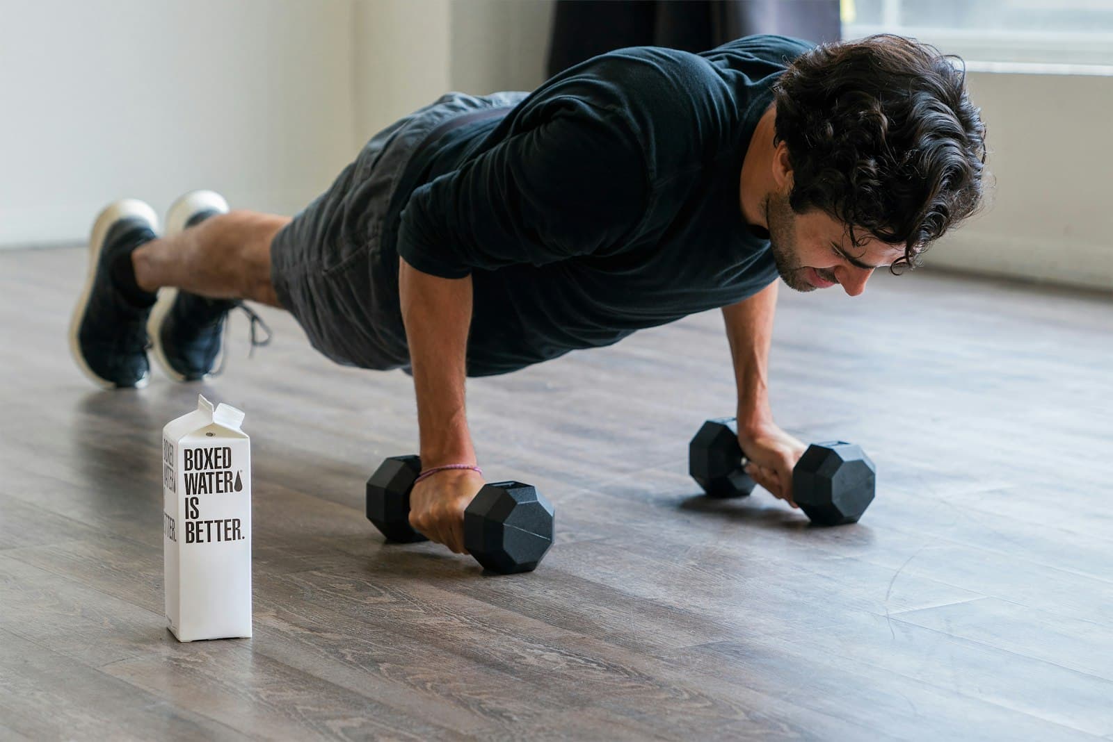 A member doing push-ups on hex dumbbells